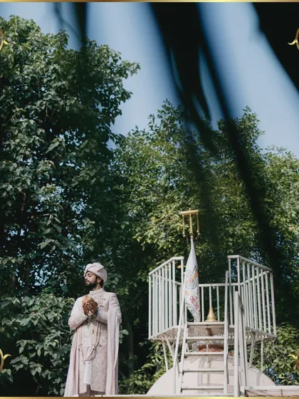 An artistic shot of the groom, framed by nature, in a moment of quiet contemplation before the ceremony.
