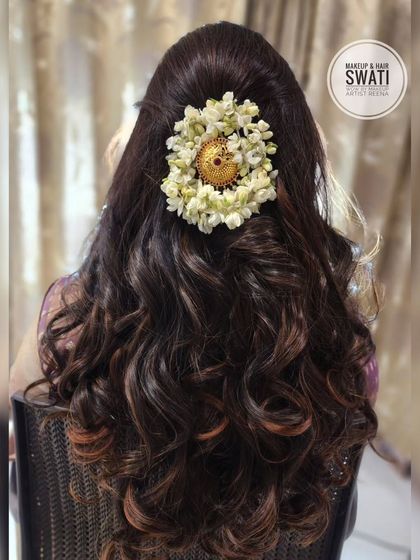 A beautiful party hairstyle by my artist Swati. The soft curls are gathered and adorned with a gajra and a traditional gold accessory.