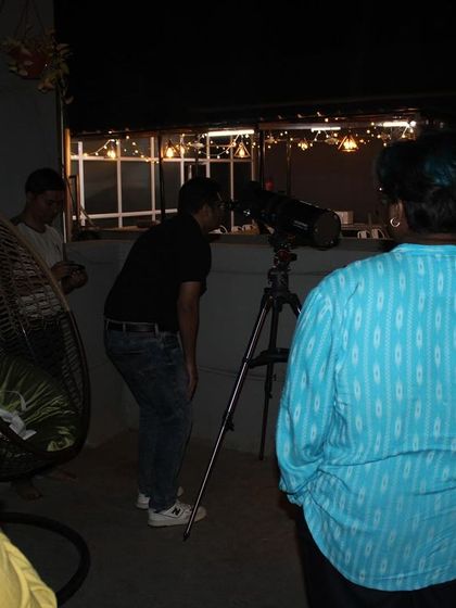 An attendee gets a hands-on experience, looking at the moon through a telescope on our rooftop. These are the moments of wonder I love to create.