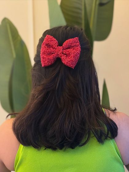 This sparkly red bow clip is perfect for parties and festive celebrations. It adds just the right amount of glitter.