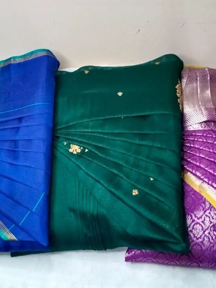A trio of sarees pleated and ready for different events.