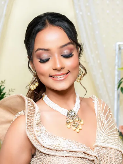 A happy, eyes-closed shot that beautifully showcases the soft, shimmery eyeshadow. This look is the epitome of soft glam, perfect for a bride who wants to look radiant and romantic.