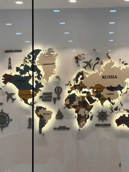 A custom backlit world map designed for a corporate boardroom. Made from layers of MDF and acrylic, this piece is both decorative and functional. The warm backlighting creates a sophisticated glow, highlighting the different continents and making it a stunning centerpiece.