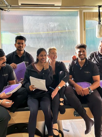 A moment of shared learning and laughter during an advanced training session. Our team's camaraderie translates to a positive studio atmosphere.