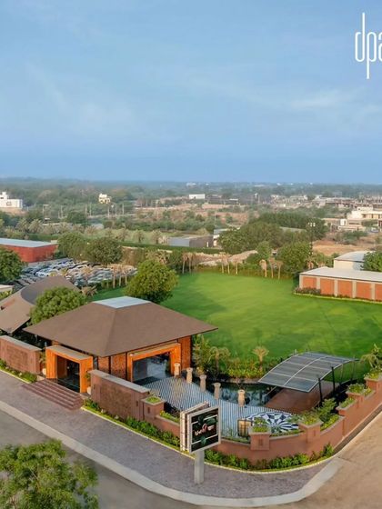 The farmhouse is designed to host large gatherings, with a sprawling green lawn providing a versatile outdoor venue space.