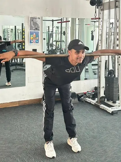 A close-up of the good morning stretch, focusing on hinging at the hips to activate the posterior chain.