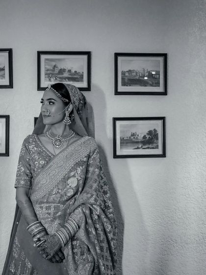 A timeless black and white portrait of a bride, her thoughtful gaze directed away from the camera, creating a classic, contemplative mood.