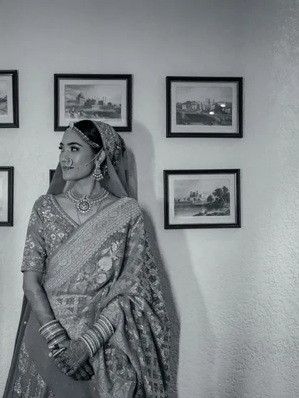 A timeless black and white portrait of a bride, her thoughtful gaze directed away from the camera, creating a classic, contemplative mood.