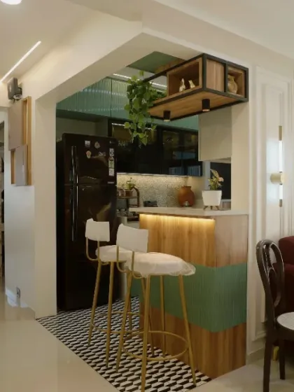 The breakfast bar with stylish high chairs serves as a casual dining spot and a bridge between the kitchen and living room.