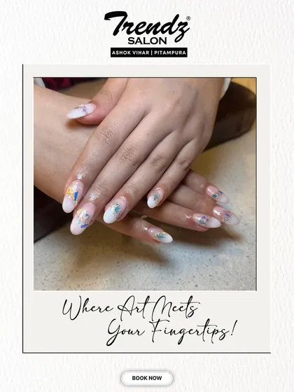 A closer view of the delicate butterfly and floral nail art. The soft colors and intricate details on the milky white base create a beautiful and romantic effect on these long extensions.