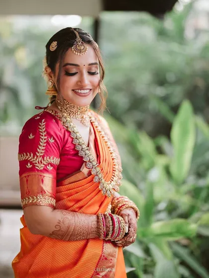 A smiling portrait of the bride. Her makeup features soft, shimmering eyeshadow and a flawless base that looks radiant and feels light.