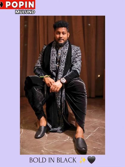 A client looking powerful in a black velvet Indo-Western outfit, complete with a heavily embroidered shawl. This is a luxurious and regal look for a grand event.