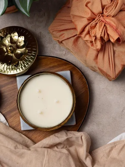 And here is the three-wick candle in a stunning gold container, paired with a warm, rust-colored Furoshiki wrap.