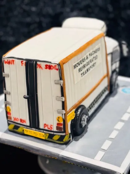 Another angle of the truck cake's rear, showcasing the precision in sculpting the doors, hinges, and license plate.