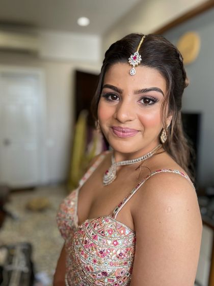 A close-up on the beautiful, soft glam makeup. The skin is radiant, the eyes are defined, and the overall look is polished and perfect.