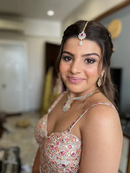 A close-up on the beautiful, soft glam makeup. The skin is radiant, the eyes are defined, and the overall look is polished and perfect.