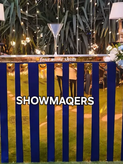 A chic bar with a royal blue and gold mirror finish, designed for a stylish private party.