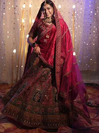 Here is to the bride in all her glory. This classic red bridal lehenga features intricate embroidery and a timeless silhouette, perfect for making your grand entrance on your wedding day.