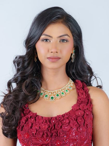 A classic editorial look with soft, open waves. This simple yet elegant hairstyle perfectly complements the model's features and the statement jewelry.