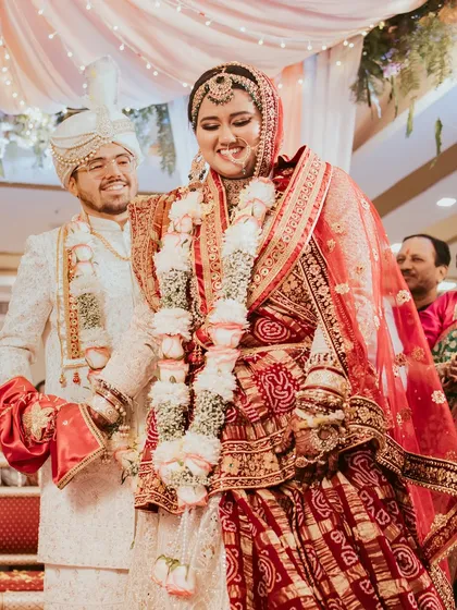 A candid moment of happiness during the wedding rituals. The groom smiles lovingly at his bride as they participate in the ceremony, showcasing the unscripted emotions that I strive to capture.
