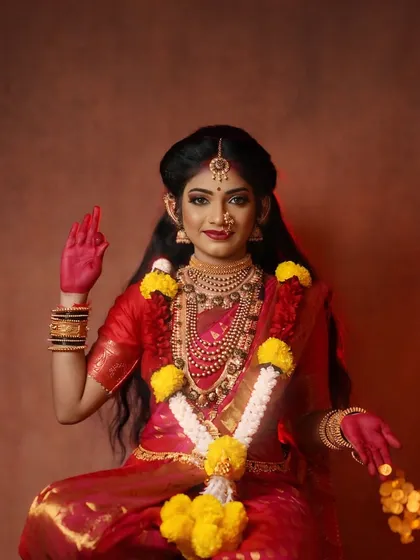 A portrait of the Goddess concept, adorned with a garland of yellow flowers and holding gold coins, symbolizing prosperity and blessings during Navratri.