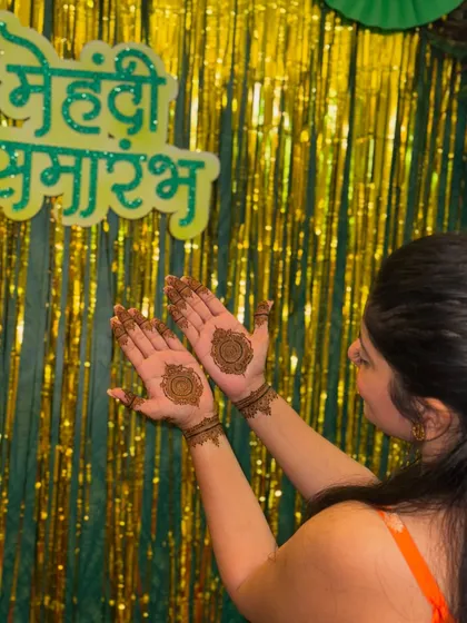 A client showing off her festive mandala mehendi at a "Mehendi Samarambh" (mehendi ceremony).