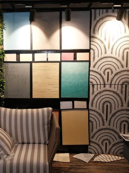 A cozy corner of our booth at the Casa Di Carnival in Bhubaneswar, featuring a comfortable striped armchair set against a backdrop of our designer tiles and wall finishes.