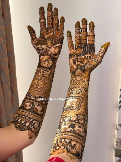 A full view of a custom bridal mehendi, showcasing different stories on each arm. One arm features a couple's portrait, while the other includes personal symbols and motifs.