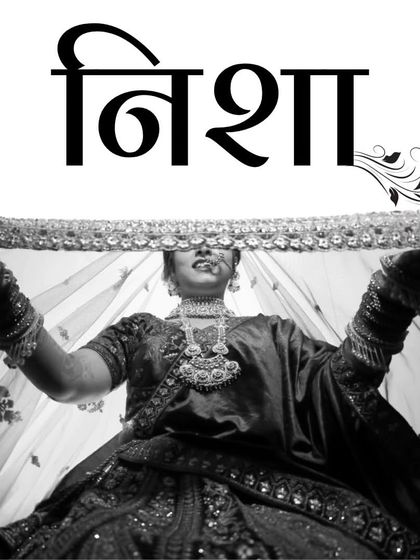 A dramatic black and white portrait of a bride named Nisha, lifting her veil. This artistic shot is both timeless and powerful.