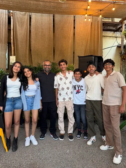 The band and friends posing for a group photo after a successful music night. It's this sense of community and togetherness that we cherish the most.