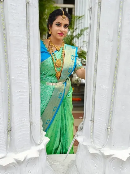 A creative shot of Kavya. Her makeup looks flawless even from a distance, which is important for event photography.