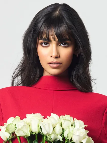 A close-up from an editorial feature where the brief was 'bold yet graceful'. I focused on a sharp, smoked-out eye and a soft nude lip to complement the model's strong features and the vibrant red styling, creating a powerful and memorable image.