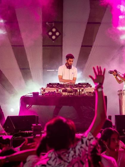 In the zone, mixing tracks while the Beat Gurus add their live percussion magic.