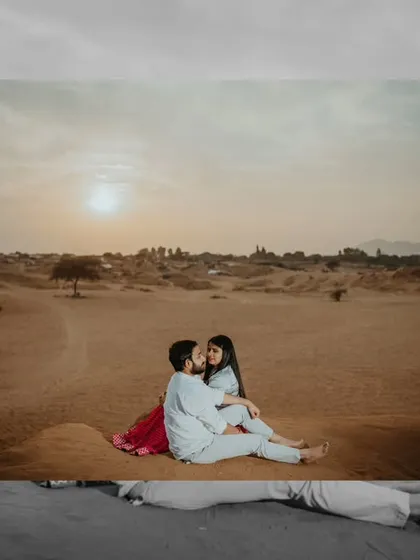 A beautiful sunset shot in the Pushkar desert. The warm golden light and serene landscape create a perfectly romantic setting for this intimate couple portrait.