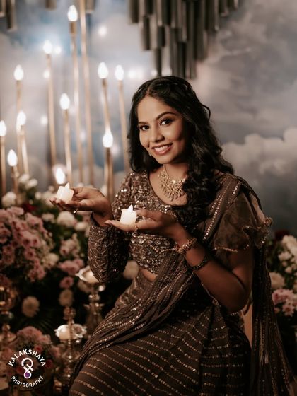 A lovely portrait of the bride holding candles during her Mehendi ceremony, with a beautiful, dreamy backdrop.
