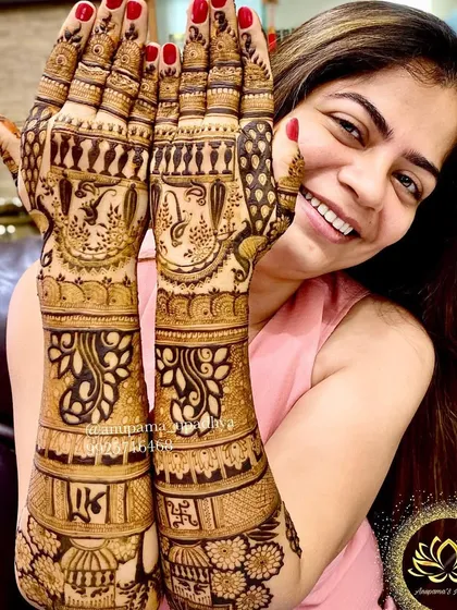 A happy client showing off her elegant backhand mehandi. The design is both traditional and stylish.