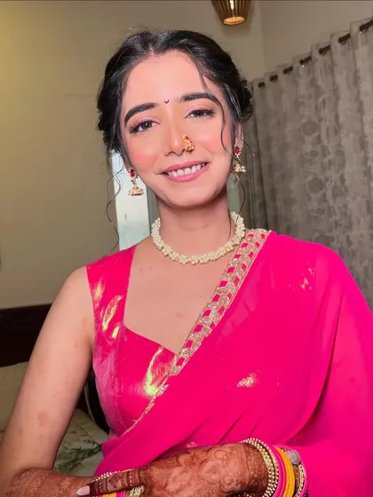 A final look at this stunning Haldi makeup. The bright pink saree and fresh makeup are a perfect combination for this joyous occasion.