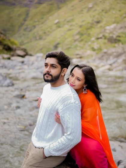 A tender moment of embrace by the river, showcasing the couple's connection amidst the natural beauty of Manali.