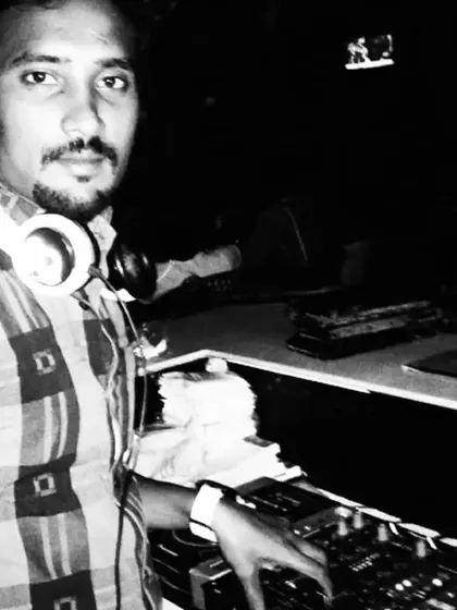 A black and white photo from a past gig. You can see the concentration as I line up the next track. Every set is a story.