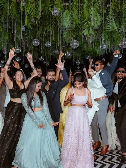The Sangeet night is all about energy. Here, I captured the bride and her friends dancing under a canopy of lush greenery and sparkling disco balls. My goal is to freeze these high-energy, fun-filled moments in time.