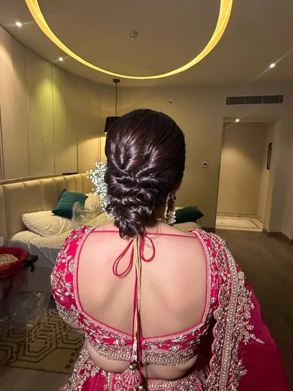 Another angle of the glossy, woven updo. You can see the clean sections and the beautiful shine on the hair, which makes this style look incredibly polished and sophisticated.