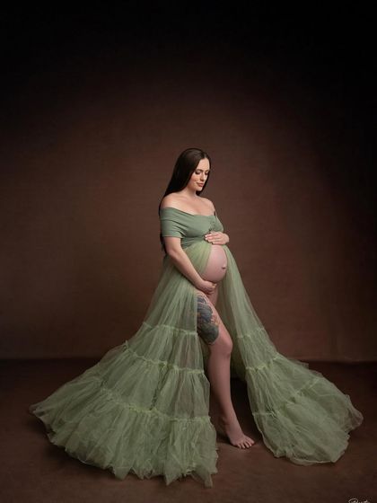 Looking down at her bump with love, this pose is full of tenderness. The layers of tulle add beautiful texture and depth to the image.
