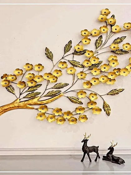 A beautiful representation of nature, this wall art features a branch laden with delicate golden flowers. Handcrafted from wrought iron, this piece brings a touch of organic elegance and antique charm to your living space.