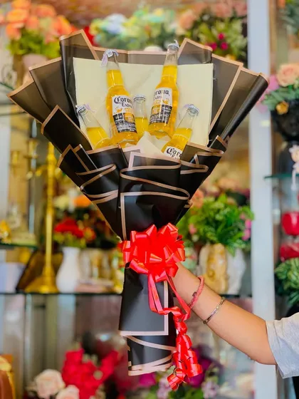 A full view of the beer bouquet being held, showcasing its size and unique presentation. It's a great alternative to traditional gifts.