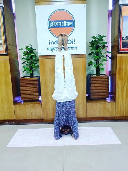Practicing Sirsasana (Headstand) at the Indian Oil office in Ashok Nagar. Inversions are great for improving focus and circulation.