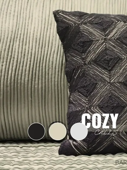 Cozy calls. A macro shot of the different fabric textures used in our bedding styling, from ribbed corduroy to geometric weaves.