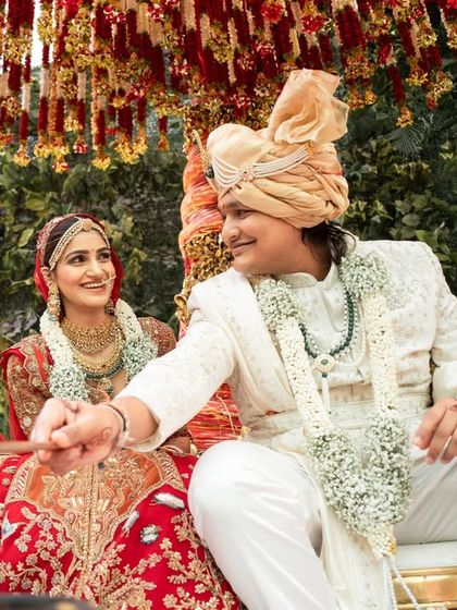 The couple sharing a look of love by the sacred fire. The flame adds a dynamic and warm element to this traditional wedding photograph.