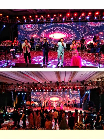 A wide shot of Sachin-Jigar performing for a wedding sangeet. This view captures the entire band on stage and the audience enjoying the show.