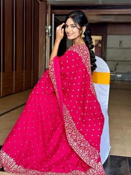 A full view of this stunning pink lehenga. The makeup is radiant and the intricate mermaid braid adds a touch of modern elegance, perfect for a wedding reception or sangeet.