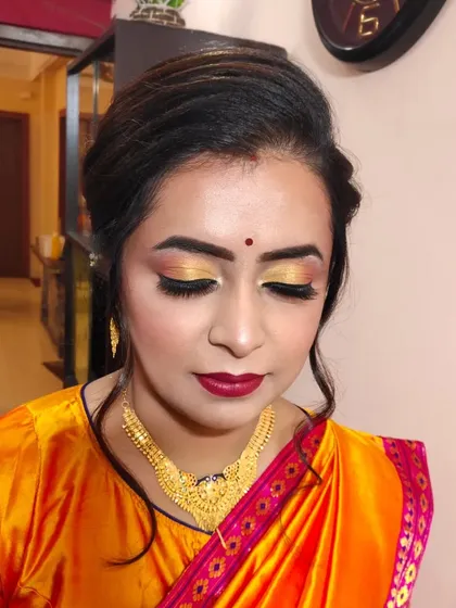 A close-up of the eye makeup, featuring a beautiful blend of gold and black with a sharp wing.